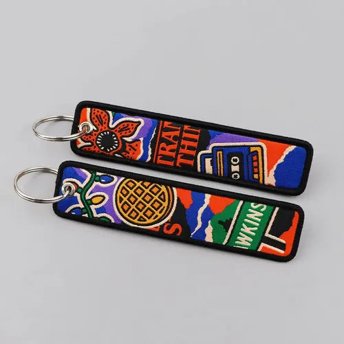 STRANGER THINGS "HAWKINS" EMBROIDERED FLIGHT TAG KEYCHAINS